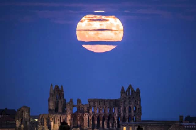The Supermoon rises above Whitby Abbey in Yorkshire. PIC: PA