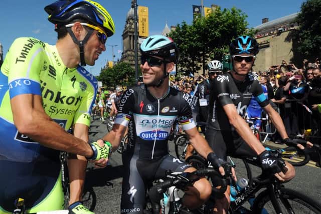 HE'S BACK: Mark Cavendish (centre) shakes hands with Alberto Contador (left) and Chris Froome at the start of of the first stage of the Tour de France n Leeds back in 2014. Picture: Bruce Rollinson