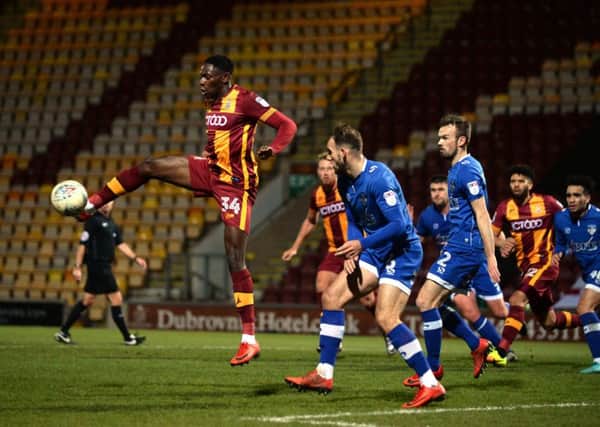 Bradford City's Omari Patrick rises to control the ball ahead of Oldham Athletic's Dan Gardner (Picture: Bruce Rollinson).