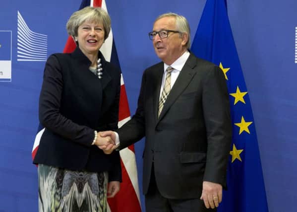 European Commission President Jean-Claude Juncker, right, greets British Prime Minister Theresa May prior to a meeting at EU headquarters in Brussels on Monday, Dec. 4, 2017. British Prime Minister Theresa May and EU Commission President Jean-Claude Juncker will hold a power lunch on Monday.