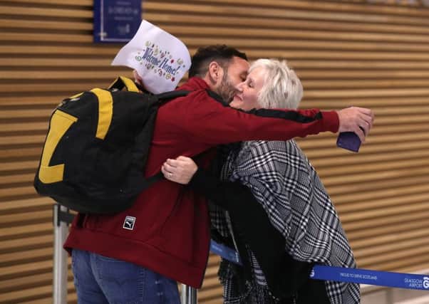 Billy Irving from Connel, Argyll,  one of the so-called Chennai Six is hugged by family as he arrives at Glasgow Airport after being released from India after serving four years in jail on weapons charges.