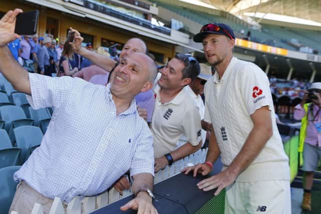 SMILE: Captain Joe Root politely poses for 'selfies' with England fans shortly after losing the second Ashes Test at the Adelaide Oval. Picture: Jason O'Brien/PA