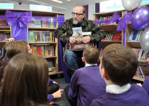 STAR GUEST: Adrian Edmondson answers pupils questions as he opens a new state-of-the-art library at Thackley Primary School in Bradford. PIC: Tony Johnson