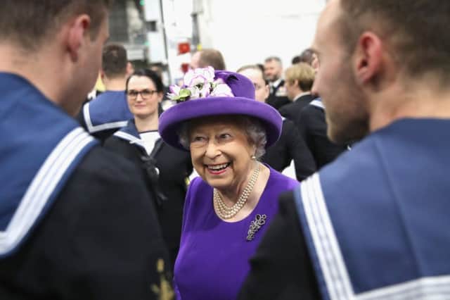 The Queen talks to members of the ship's company, during the commissioning of HMS Queen Elizabeth, Britain's biggest and most powerful warship, into the Royal Navy Fleet