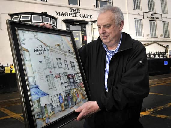 The Magpie restoration nears completion after the fire devastated the property. Co owner Ian Robson with a painting depicting the building in full glory. Picture by Richard Ponter 175412j