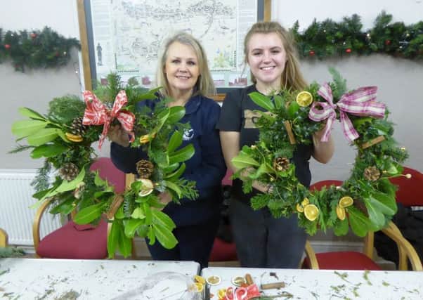 Jackie East, with daughter Hannah making Christmas wreaths, nominated the village hall for the donation.