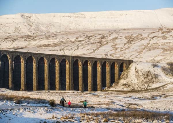 Walkers at Ribblehead Viaduct in Yorkshire - PA