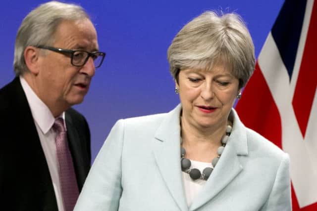 British Prime Minister Theresa May, right, and European Commission President Jean-Claude Juncker. AP Photo/Virginia Mayo)