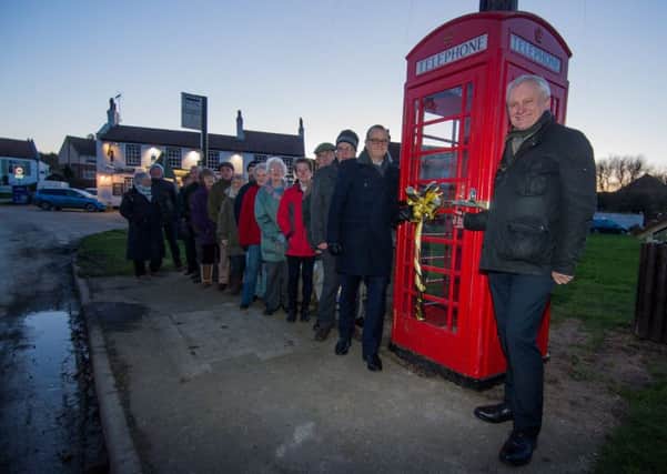 The East Yorkshire village of Atwick has its iconic phone box back after a campaign by villagers  Pictured (left )residents, along with David Pincott,from BT and Graham Stuart, MP, for Beverley and Holderness