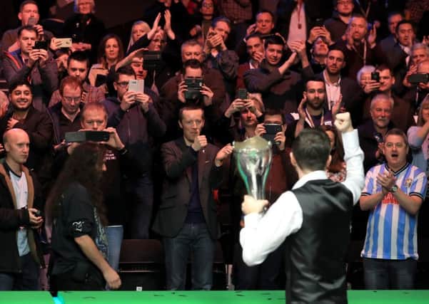 Mark Selby celebrates in front of the fans with the Betway UK Championship trophy after victory over Ronnie O'Sullivan in last year's final.