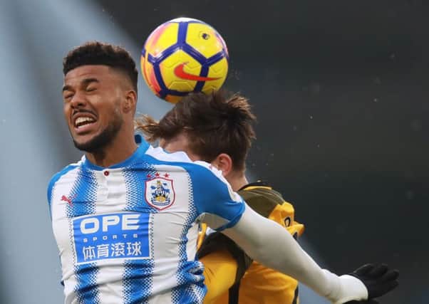 Huddersfield Town's Elias Kachunga (left) and Brighton & Hove Albion's Davy Propper battle for the ball.