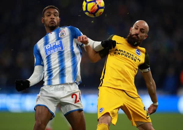 Huddersfield Town's Steve Mounie (left) and Brighton & Hove Albion's Bruno battle for the ball.