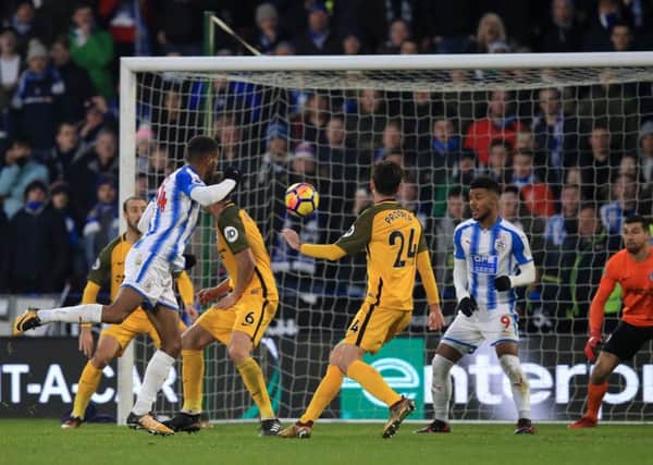 Huddersfield Town's Steve Mounie scores his and his side's second goal against Brighton at the John Smith's Stadium, Huddersfield (Picture: Mike Egerton/PA Wire).