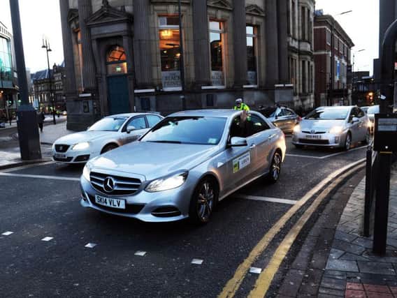 Private hire vehicles take part in a 'slow drive' protest in Leeds. Picture: Simon Hulme
