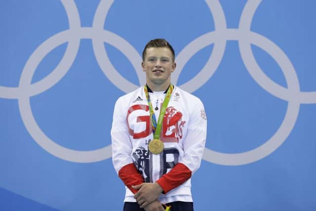 Adam Peaty celebrates during the medal ceremony after setting a new world record in the men's 100-metre breaststroke final at the Rio Olympics. Picture: AP/Michael Sohn)