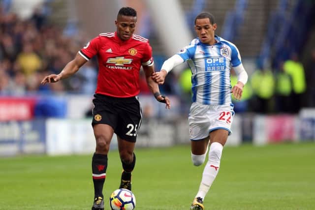 Manchester United's Antonio Valencia (left) and Huddersfield Town's Tom Ince battle for the ball