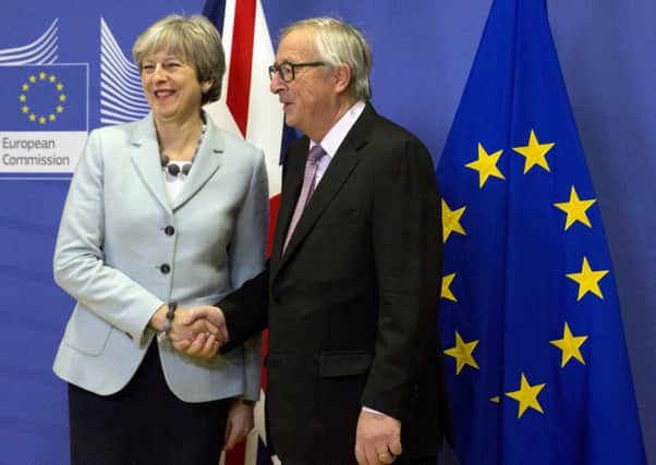 DEAL IN MOTION: Prime Minister Theresa May is greeted by European Commission president Jean-Claude Juncker prior to a meeting at EU headquarters in Brussels last Friday.