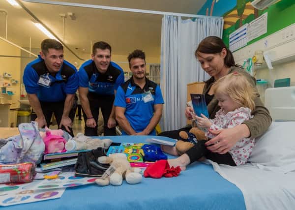 Date: 13th December 2017.
Picture James Hardisty.
Players from Yorkshire County Cricket Club, visited the Children's Leeds Congential Heart Unit to hand out gifts to the patients. The Children's Heart Surgery Fund are the club's current charity partner and this is the second year running the players have made such a visit. Pictured YCC players Andrew Hodd,  Alex Lees, and Jack Brooks, chatting to Ayva Sinclair, aged 19 months, of Leeds, with her mum Carla Scarfe.
