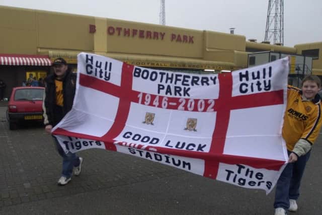 GOODBYE: Graham Alexander and his son Mark parade their flag outsisde of Boothferry Park before Hull City's last game at the ground.