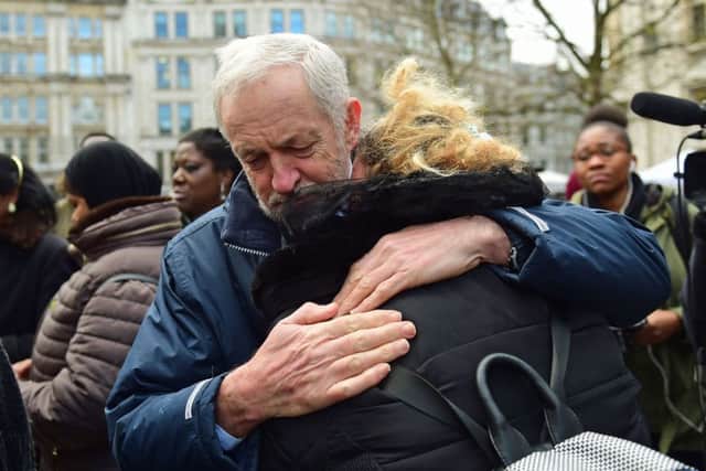 Labour Party leader Jeremy Corbyn hugs a woman after the Grenfell Tower National Memorial Service at St Paul's Cathedral in London