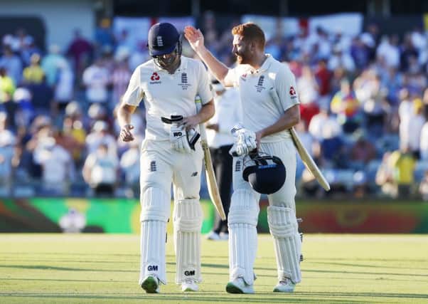 CONGRATULATIONS: England's Dawid Malan and Jonny Bairstow walk off at stumps at the end of day one at the WACA. Picture: Jason O'Brien/PA
