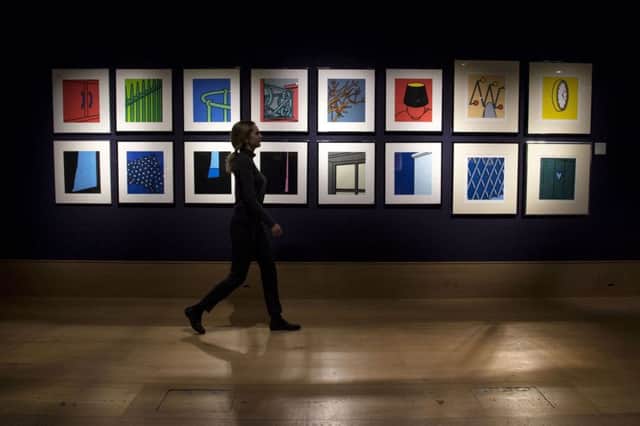 A member of staff walks past screenprints entitled Some Poems of Jules Laforgue by Patrick Caulfield during a photo call for Bonhams Prints and Multiples, in New Bond Street, London