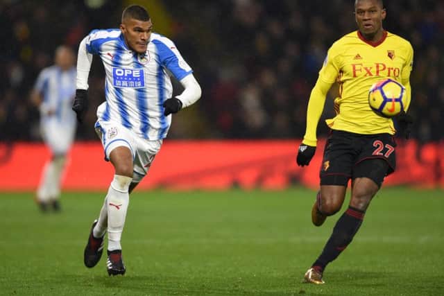 Huddersfield Town's Collin Quaner (left) and Watford's Christian Kabasele battle for the ball at Vicarage Road. Picture: Daniel Hambury/PA