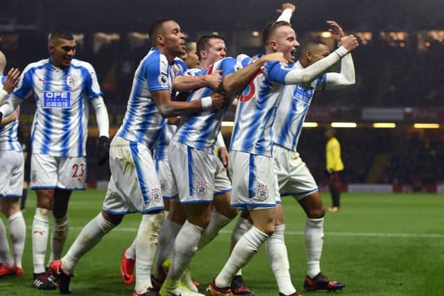 TOP MAN: Huddersfield Town's Laurent Depoitre (obscured) celebrates scoring his side's third goal of the game at Vicarage Road. Picture: Daniel Hambury/PA