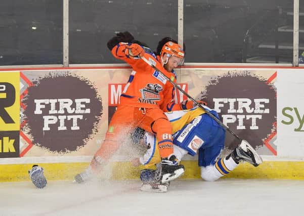 DOWN BUT FAR FROM OUT: Ben O'Connor collides with the boards under pressure against Fife Flyers in Sunday night's 3-1 defeat. Picture: Dean Woolley.
