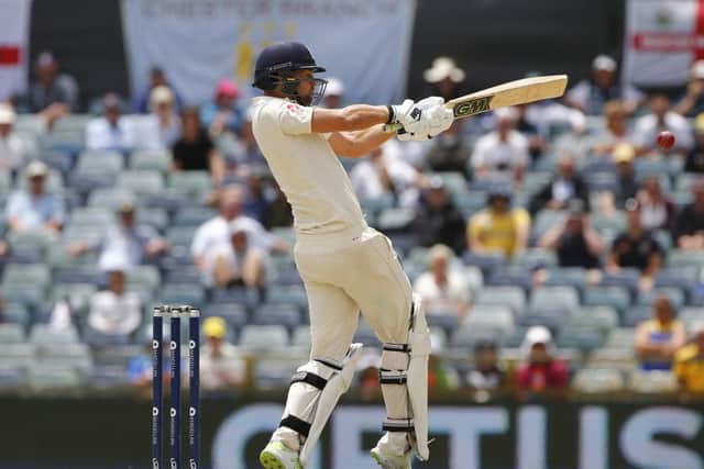 England's Dawid Malan pulls for four on to the leg side, adding a half century to his first innings 100 at the WACA. Picture: Jason O'Brien/PA