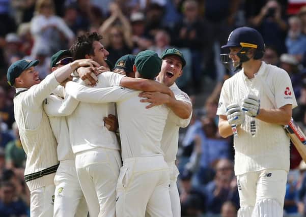 Australias players celebrate taking the wicket of Englands Chris Woakes, right, which won the third Test and secured the Ashes (Picture: Jason OBrien/PA Wire).