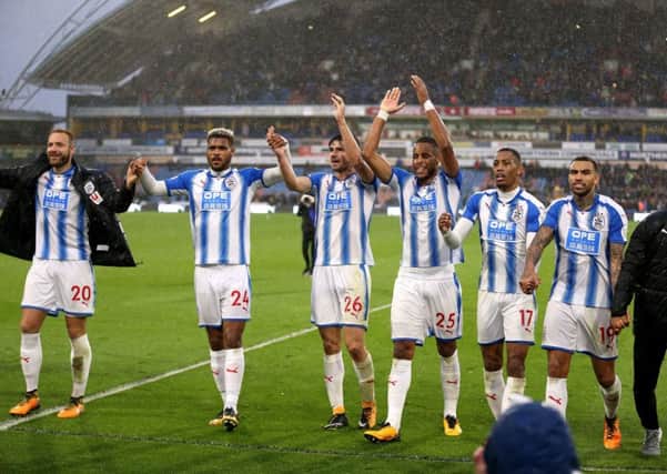 Huddersfield Town's (left-right) Laurent Depoitre, Steve Mounie, Christopher Schindler, Mathias Jorgensen, Rajiv van La Parra, Danny Williams and Elias Kachunga celebrate their win over Manchester United.