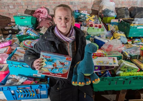 Date: 18th December 2017. Picture James Hardisty. Sammi Abbott, with some of the toys that have been donated by residents of Leeds, following a theft at St Richard's Church, Kentmere Avenue, Seacroft, Leeds. Sammi, would like to thank the people of Leeds, for their generosity, she has again enough toys to hand out to disadvantaged youngsters for Christmas this year.
