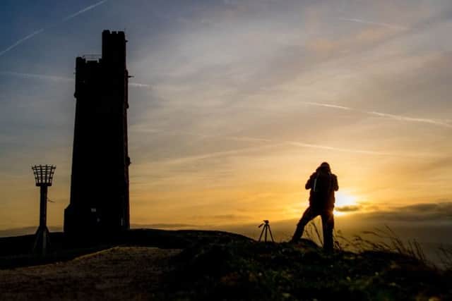 SUNSET: A photographer captures the sunset from the ancient Castle Hill site which overlooks Huddersfield. PIC: Charlotte Graham