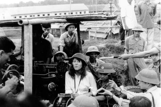 to, American actress and activist Jane Fonda is surrounded by soldiers and reporters as she sings an anti-war song near Hanoi during the Vietnam War in July 1972. (AP Photo/NIHON DENPA NEWS, File).