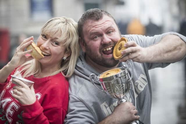 World Pie Eating Champion Martin Appleton-Clare (right) with the fastest lady Vicky Lindley after competing during World Pie Eating Championships 2017  in Wigan