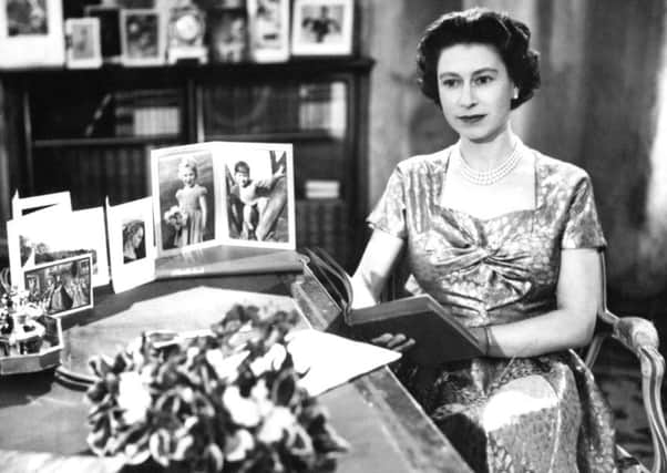The Queen Elizabeth II in a gold lame dress recording her Christmas Day message to the Commonwealth in the Long Library at Sandringham in 1957.