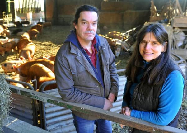 Jon and Charlotte Clarkson with some of the rare breed pigs at Kiplingcotes Farm in East Yorkshire.