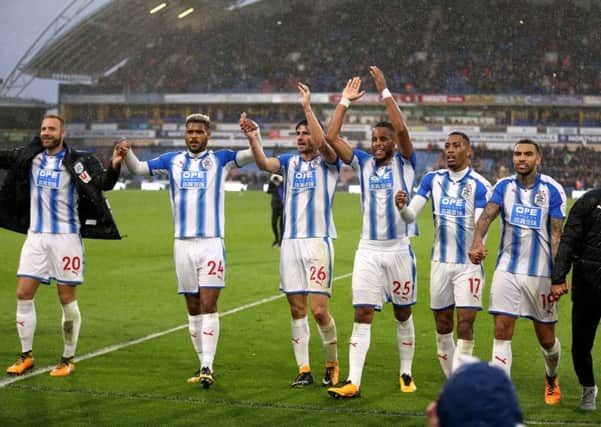 Huddersfield Town's (left-right) Laurent Depoitre, Steve Mounie, Christopher Schindler, Mathias Jorgensen, Rajiv van La Parra, Danny Williams and Elias Kachunga celebrate their win after the Premier League match at the John Smith's Stadium, Huddersfield.