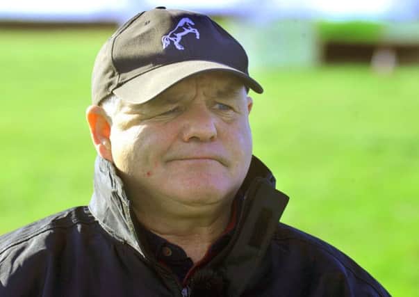 Trainer Brian Ellison watching some of his horses on the gallops near to Norton .
