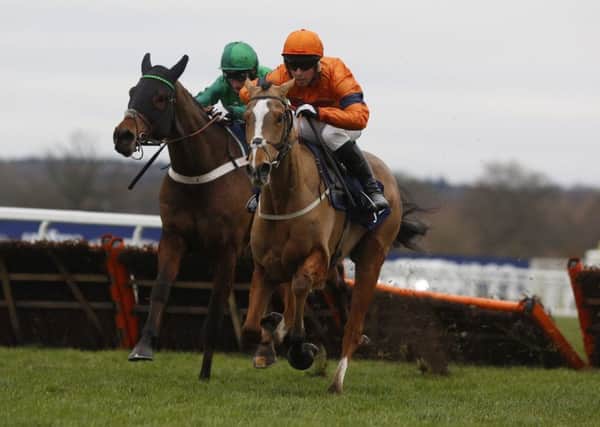 Sam Spinner ridden by Joe Colliver lead L'Ami Serge and Daryl Jacob over the last flight before going on to win The JLT Reve De Sivola Long Walk Hurdle Race run during day two of the Christmas Racing Weekend at Ascot Racecourse. (Picture: Julian Herbert/PA Wire)