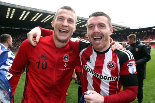GREAT DAY: Paul Coutts, left, and John Fleck celebrate winning the League One title at Bramall Lane last season. Picture: Nick Potts/PA.