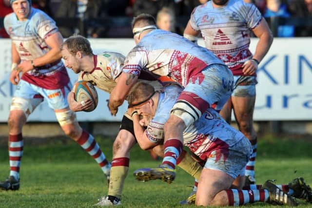 Doncaster Knights' Michael Heaney looks for support as Titans' Sam Nixon and Rob Louw tackle. (Picture: Tony Johnson)