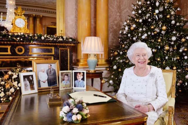Queen Elizabeth II sits at a desk in the 1844 Room at Buckingham Palace, London, after recording her Christmas Day broadcast to the Commonwealth. Picture: John Stillwell/PA Wire