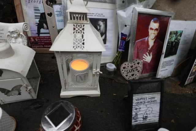 Tributes are left at the home of singer George Michael in Goring-on-Thames, Oxfordshire, on the one year anniversary of his death. Picture: Steve Parsons/PA Wire