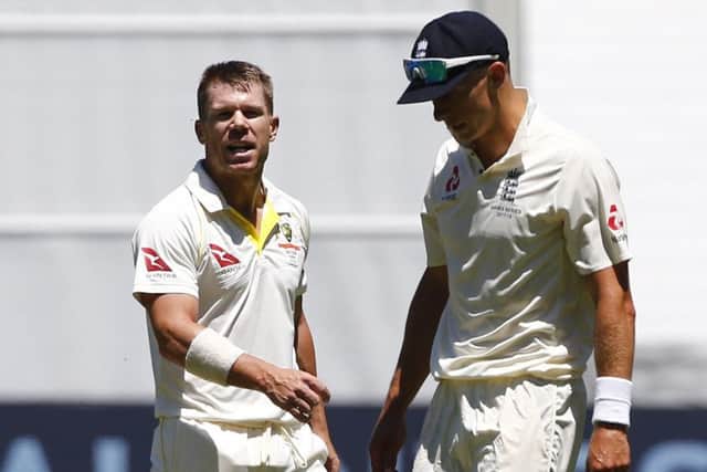 Australia's David Warner exchanges words with  England's Tom Curran during day one of the Ashes Test match at the Melbourne