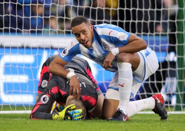 Huddersfield Town goalkeeper Jonas Lossl is tended to by Mathias Jorgensen after being injured in the Boxing Day draw with Stoke City (Picture: Richard Sellers/PA Wire).