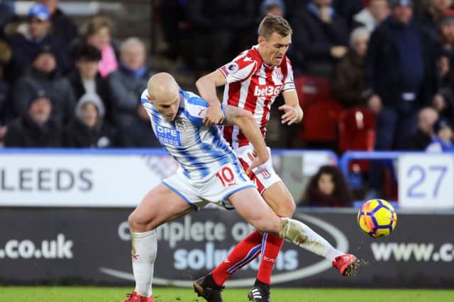 Huddersfield Town's Aaron Mooy (left) and Stoke City's Darren Fletcher battle for the ball at the John Smith's Stadium, Huddersfield. Picture: Richard Sellers/PA