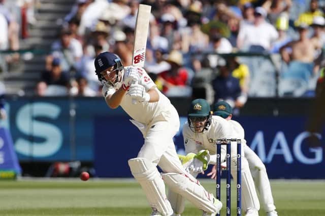 IN THE GROOVE: England's Joe Root plays the ball through mid-wicket as Australia wicket-keeper Tim Paine looks on during day two at the MCG. Picture: Jason O'Brien/PA