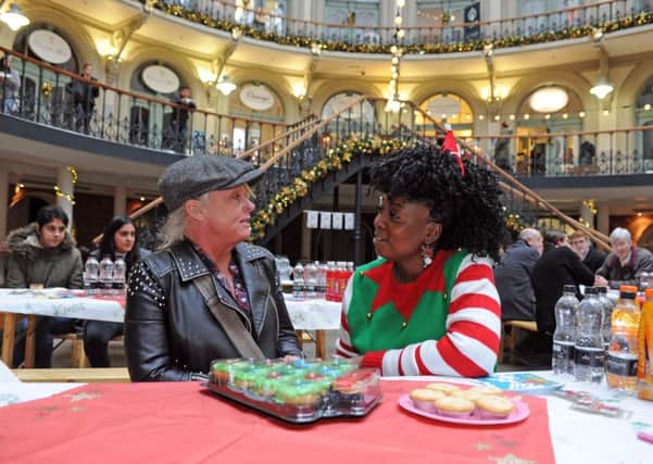 Marvina Newton, right,  founder of the Leeds charity Angels of Youth chats to Dana Lockwood at the Corn Exchange on Christmas Eve. Picture Tony Johnson.